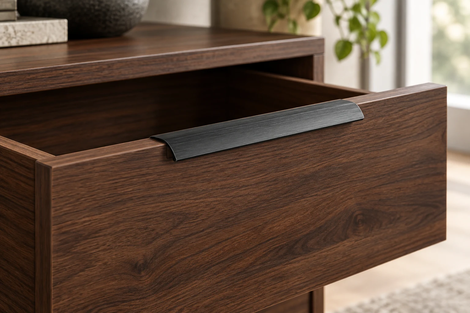 Edge Pull Profile · Charcoal curved profile on a walnut drawer edge